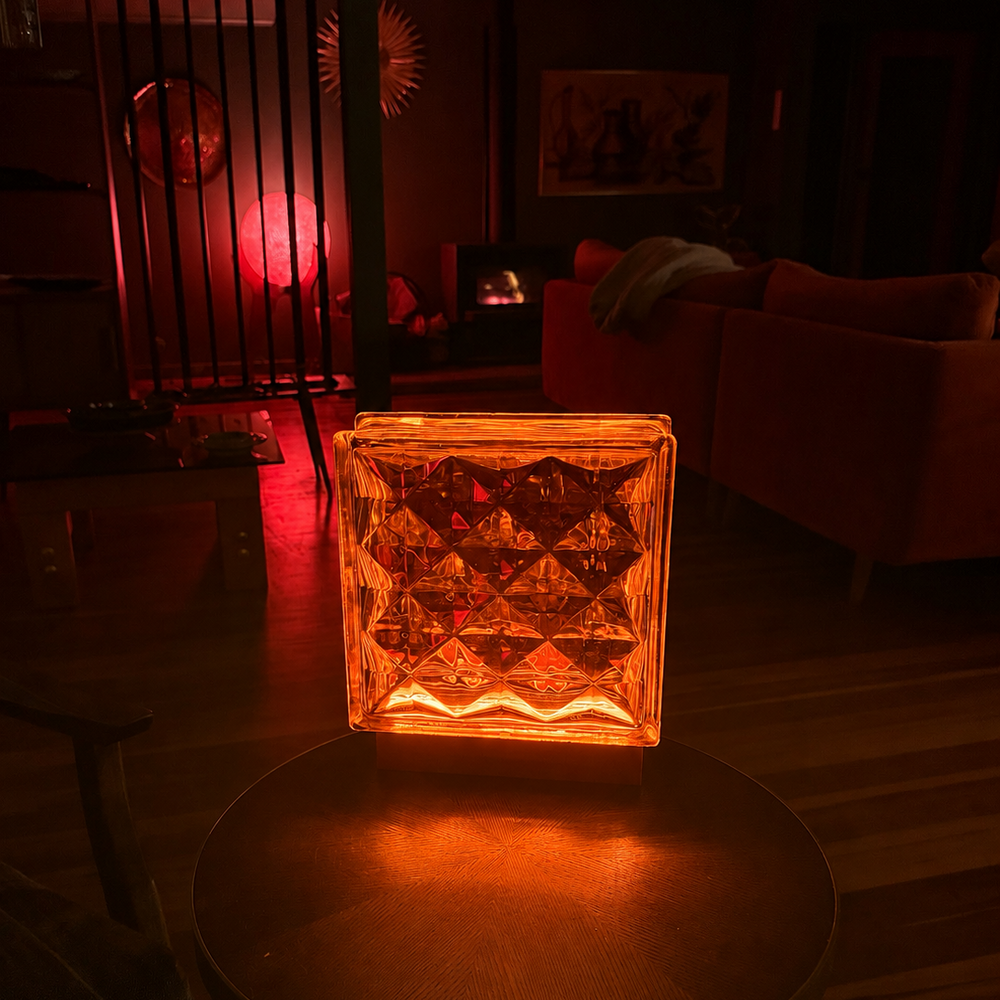King Diamond Bloc Lamp displayed on a wooden table, showing its faceted diamond glass